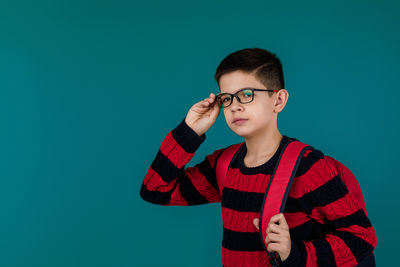 Young man standing against clear blue sky