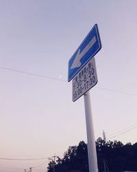 Low angle view of road sign against sky