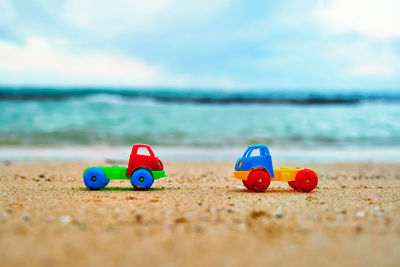Surface level view of toy cars at beach