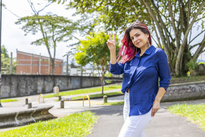 Happy woman standing against plants