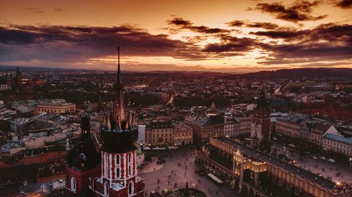 High angle view of city against cloudy sky during sunset