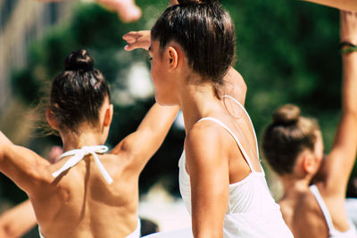 Rear view of people standing outdoors