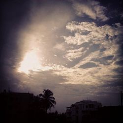 Low angle view of buildings against cloudy sky