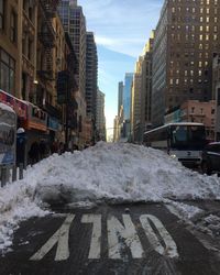 Snow covered road in city