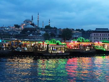 Boats in river with church in background