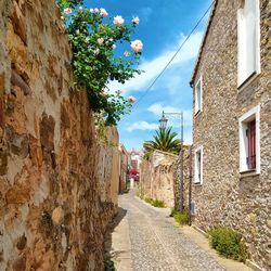 Narrow street amidst buildings against sky