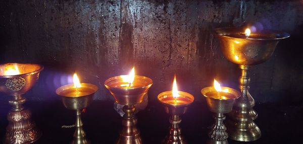 Illuminated diyas side by side