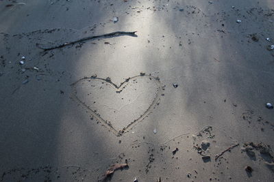 High angle view of heart shape on sand