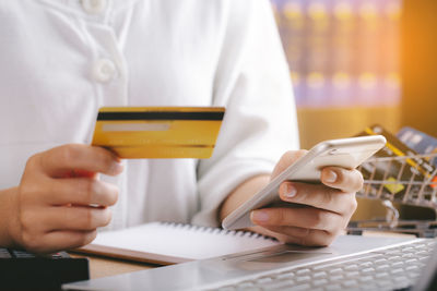 Midsection of man using mobile phone