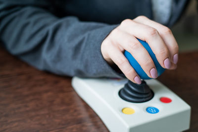 Close-up of person operating joystick