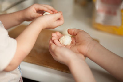 Close-up of hands holding girl