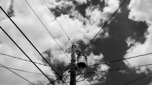 Low angle view of electricity pylon against sky