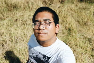 Portrait of young man wearing eyeglasses on land