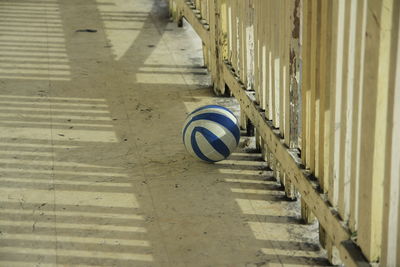 High angle view of soccer ball by railing