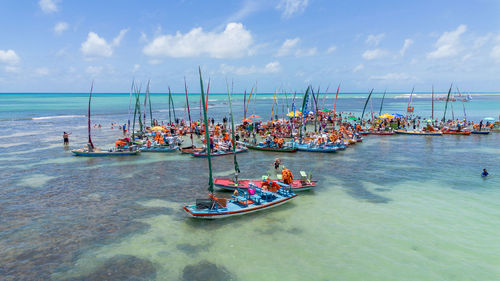 Boats in sea against sky