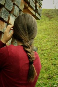 Rear view of woman with braided hair standing outdoors