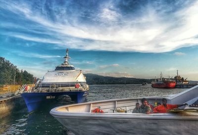 Boats moored in sea against sky