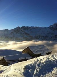 Scenic view of snow covered mountains against sky