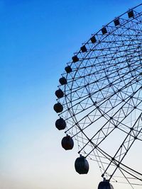 Low angle view of ferris wheel against clear sky