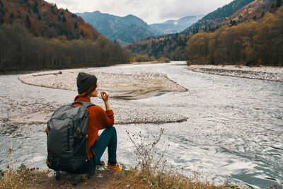 Rear view of man and woman looking at mountains