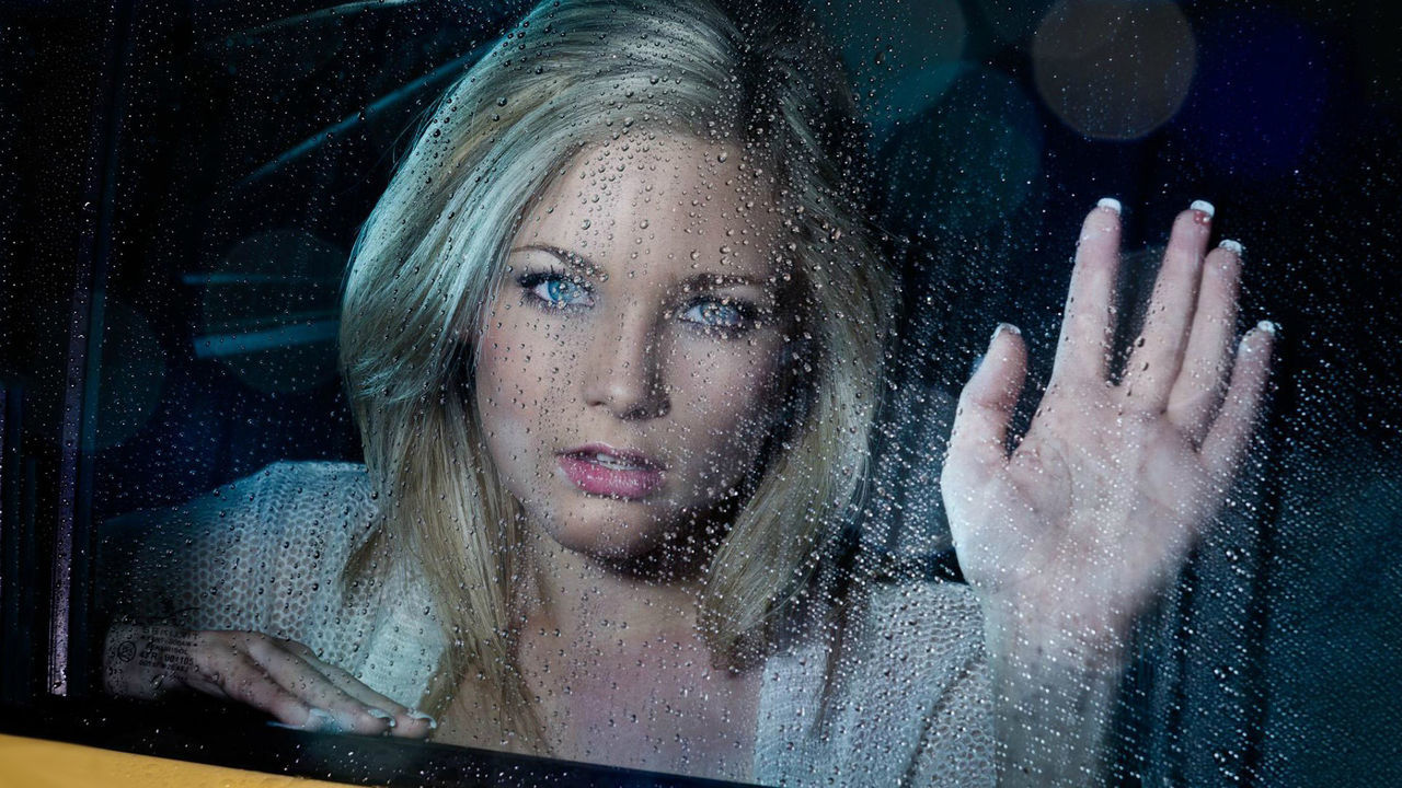 one person, portrait, women, adult, headshot, indoors, young adult, glass, looking, window, female, transparent, blue, human face, person, hand, wireless technology, technology, hairstyle, blond hair, emotion, front view, sadness