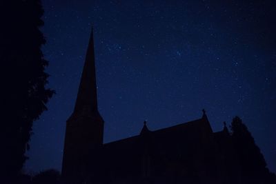 Low angle view of built structure against sky at night