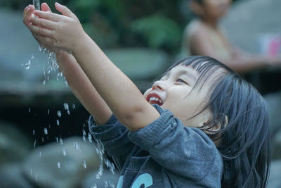 Close-up portrait of cute baby in water