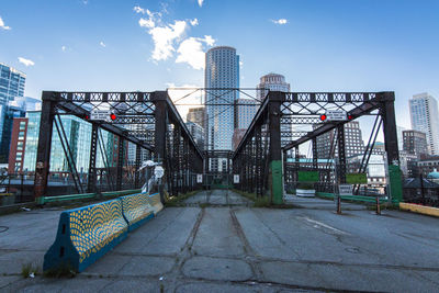View of city street with buildings against sky
