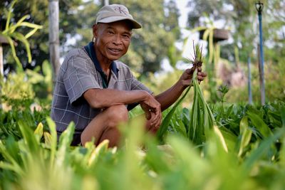 Portrait of senior smiling farmer in vegetable garden