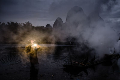 Man in water at night