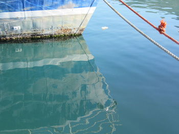 High angle view of ship tied by rope at harbor