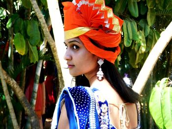 Rear view of woman wearing orange turban during traditional ceremony