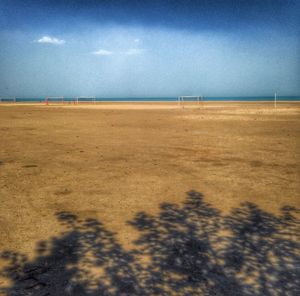 Scenic view of beach against cloudy sky