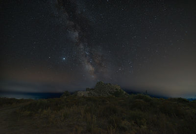 Milky way over an ancient nuraghe in sardinia