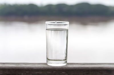 Close-up of water splashing in front of glass