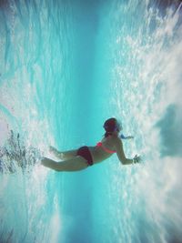 Woman jumping in sea