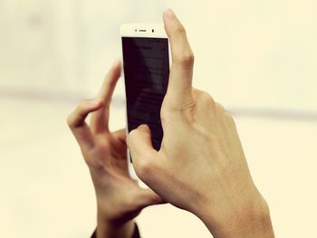 Midsection of man using mobile phone