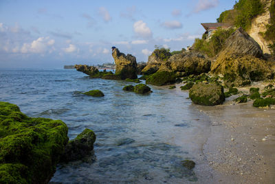 Rock formation on sea against sky