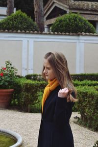 Side view of woman standing at park