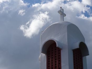 Low angle view of church against cloudy sky