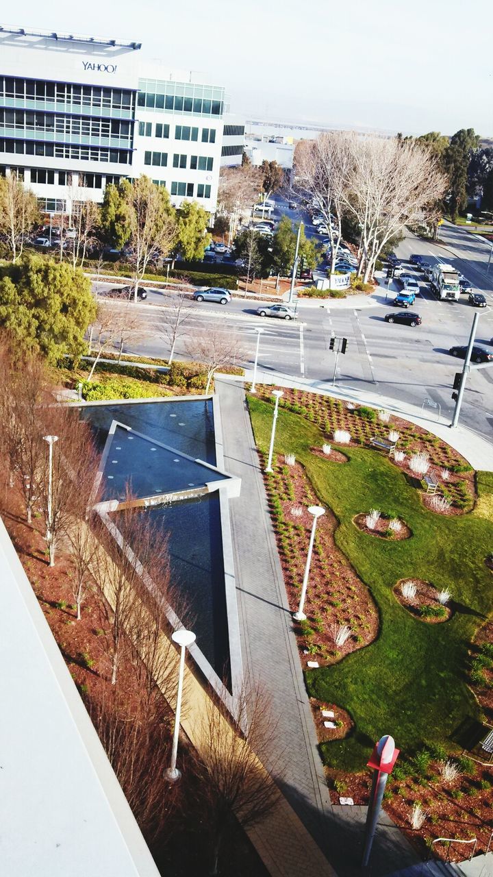 building exterior, architecture, built structure, city, high angle view, tree, residential building, building, residential structure, house, street, car, day, outdoors, transportation, no people, road, plant, sunlight, residential district