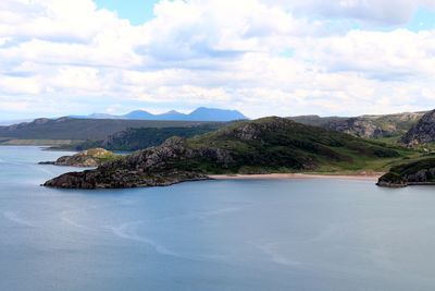 Scenic view of sea and mountains against sky