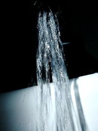 Close-up of water splashing against black background