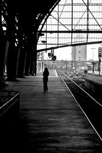 Rear view of silhouette woman walking in corridor