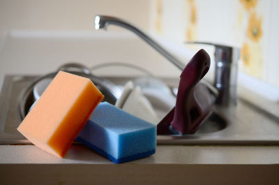 Cleaning sponges on kitchen sink full of dishes