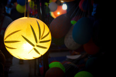 Close-up of illuminated lantern hanging at market stall