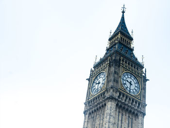 Low angle view of clock tower against clear sky