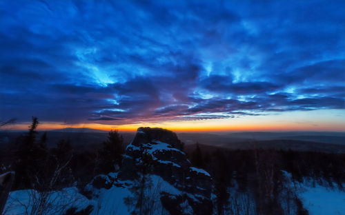 Scenic view of snowcapped mountains against sky during sunset