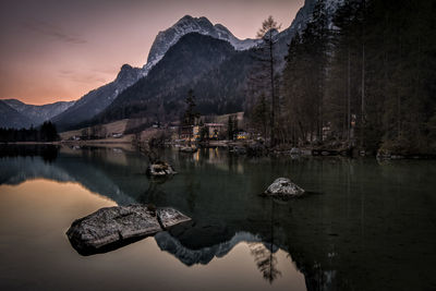 Scenic view of lake against sky at sunset