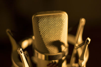 Close-up of microphone against black background